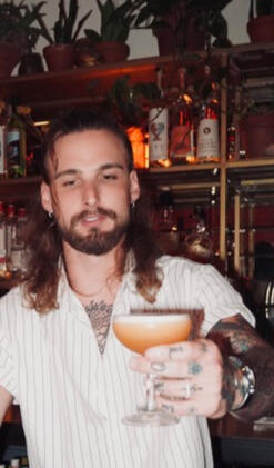 Tracer Sherwood — Professional Bartender in Austin, Texas Portrait of Tracer Sherwood, professional mixologist with Black Orchid Bar Co., standing against a neutral backdrop. Austin private bartender, luxury event bartender, elite craft cocktail specialist.